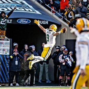 Christian Watson Green Bay Packers Unsigned Leaping for a Touchdown Photograph