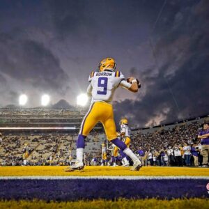 Joe Burrow LSU Tigers Unsigned White Jersey Warming Up At Night Under The Spotlights Photograph