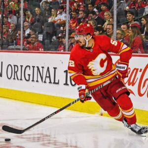 MacKenzie Weegar Calgary Flames Unsigned Carries the Puck Photograph