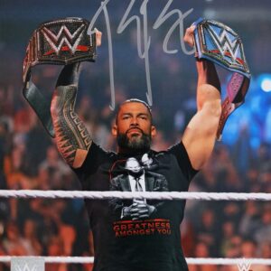 Roman Reigns WWE Autographed 8" x 10" Raising Titles Photograph